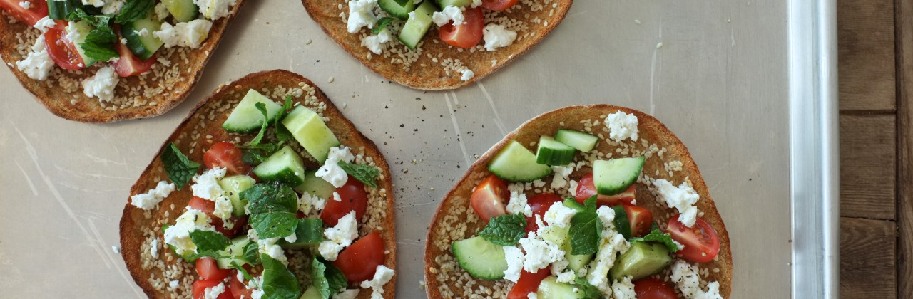 Sesame Broiled Pitas with Tomatoes, Cucumber, Mint & Feta